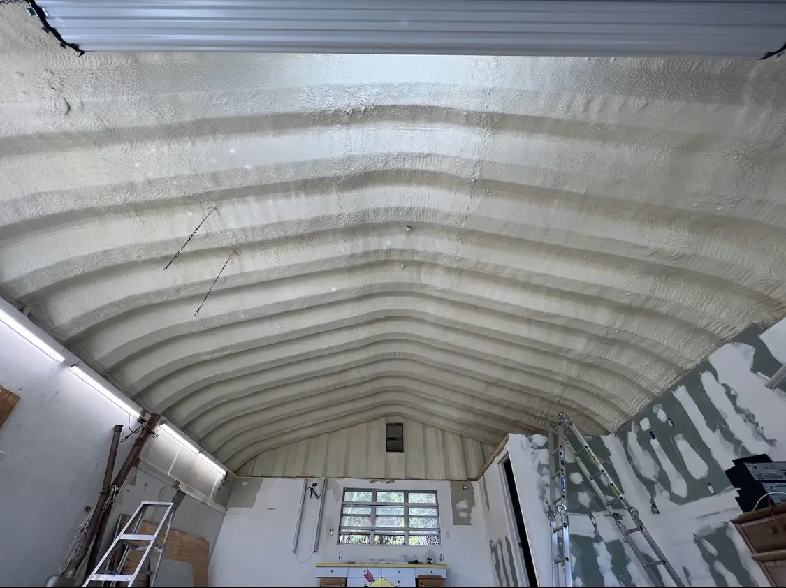 Spray polyurethane foam applied to the underside of a metal roof deck in Solon